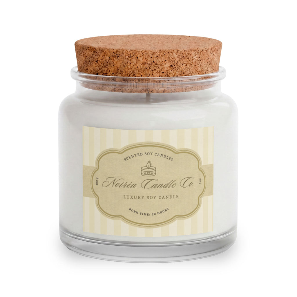 A Noiréa soy candle in a clear glass jar with white wax, a beige striped label, and a brown cork lid, shown on a white background.